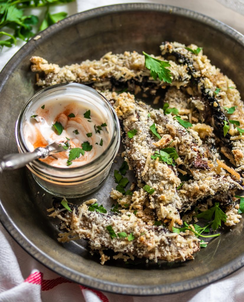 A plate of portobello mushroom fries with a side of Sriracha mayo