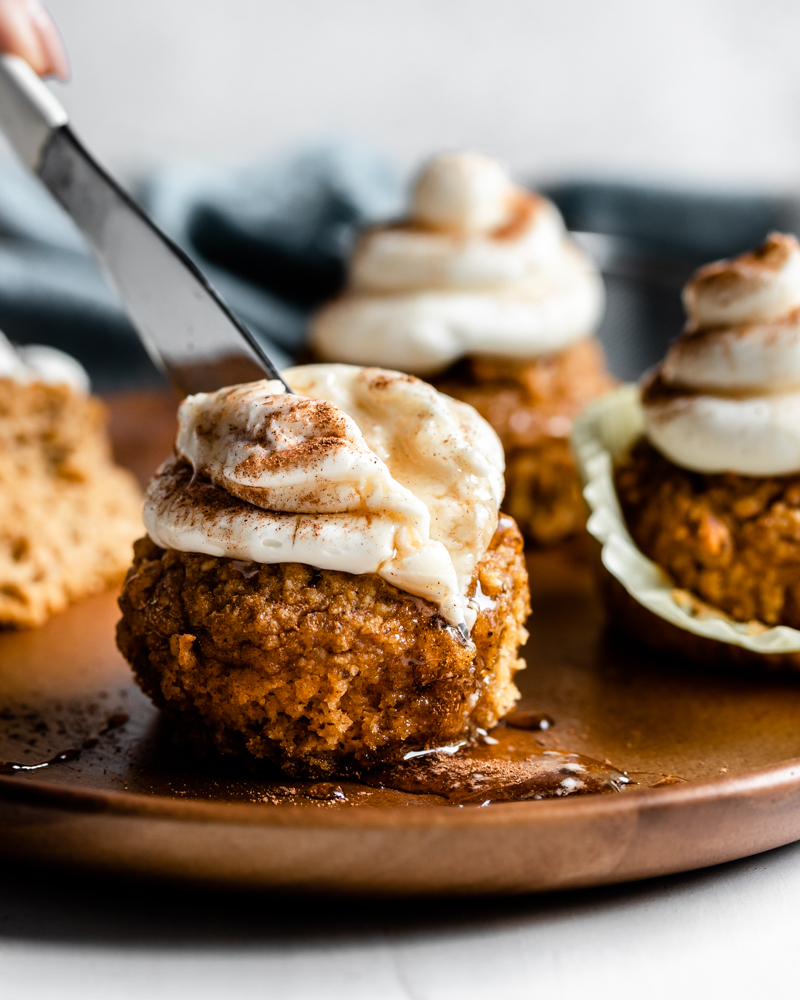 knife slicing muffin on a wood plate