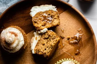 Muffin sliced open on a wooden plate