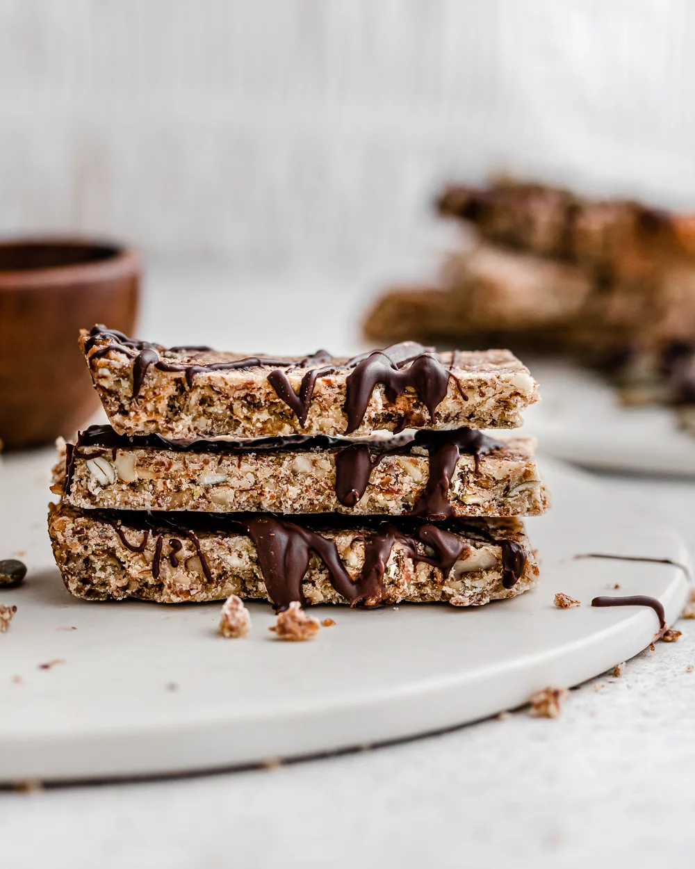 A stack of sliced granola bars with a chocolate drizzle